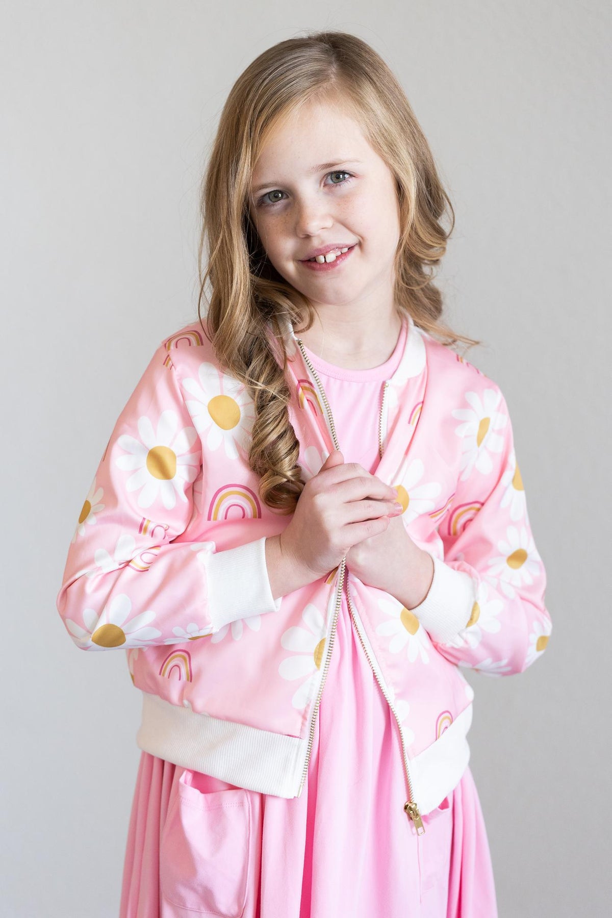 a girl in a pink jacket