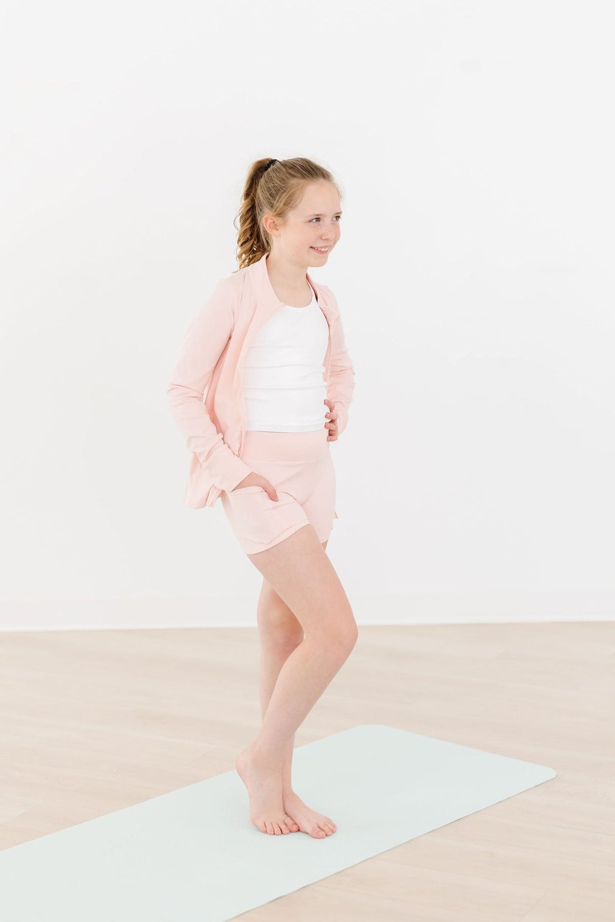 a girl standing on a mat