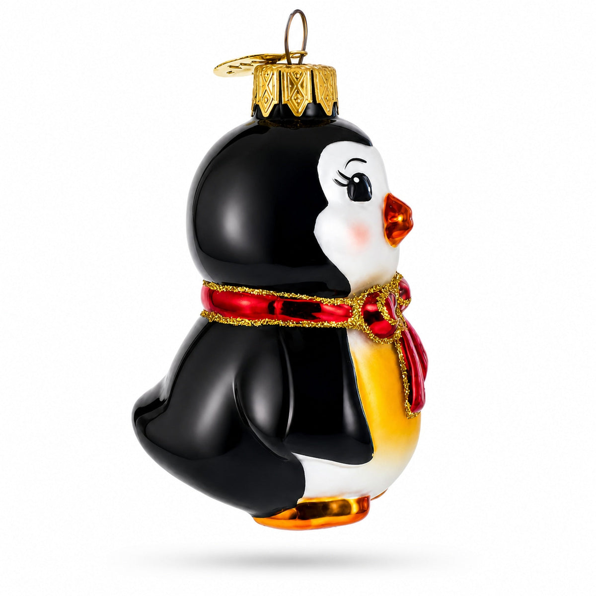 a penguin ornament with a red scarf