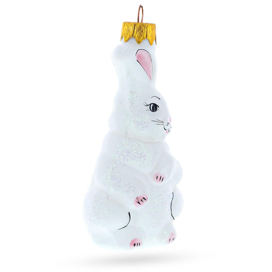 a white bunny ornament with a gold top