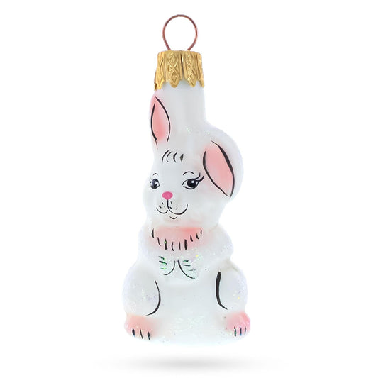 a white bunny ornament with a gold top