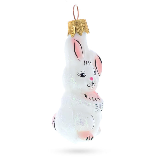a white bunny ornament with a gold top
