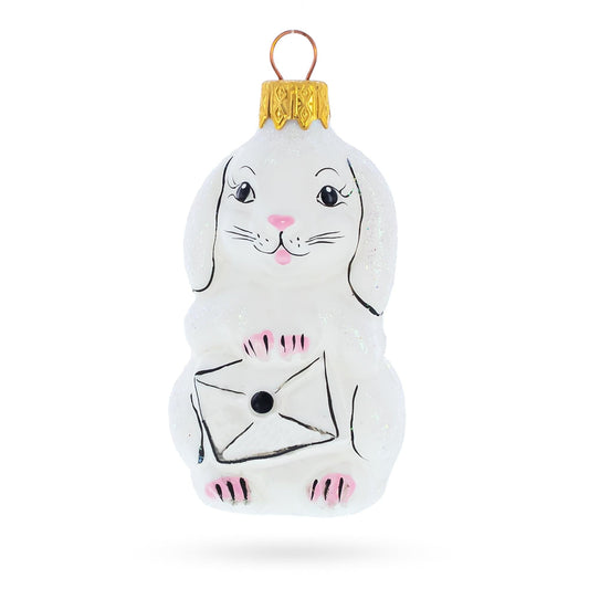a white bunny ornament with a letter