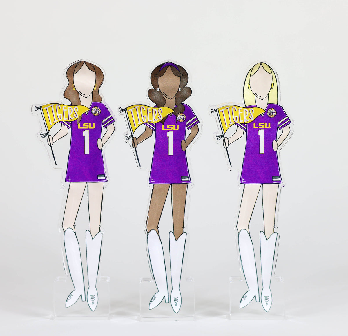 a group of paper cutouts of women wearing purple and white uniforms