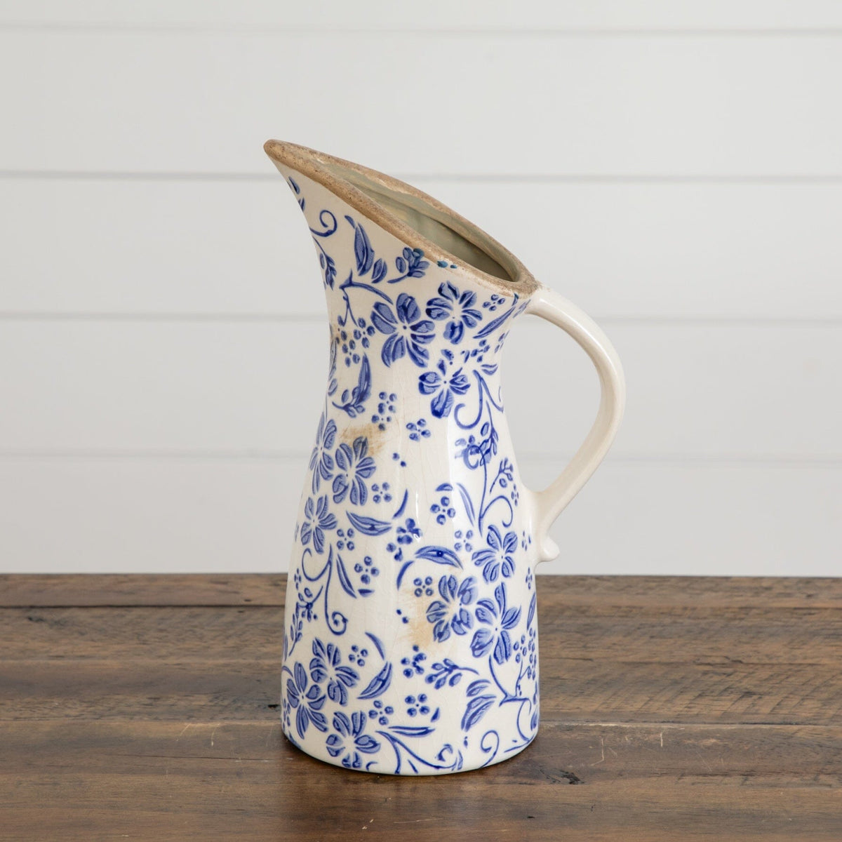 a blue and white vase with a handle