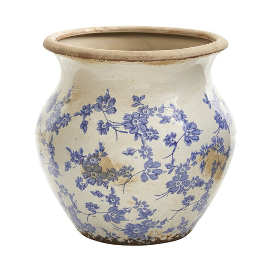 a blue and white vase with flowers