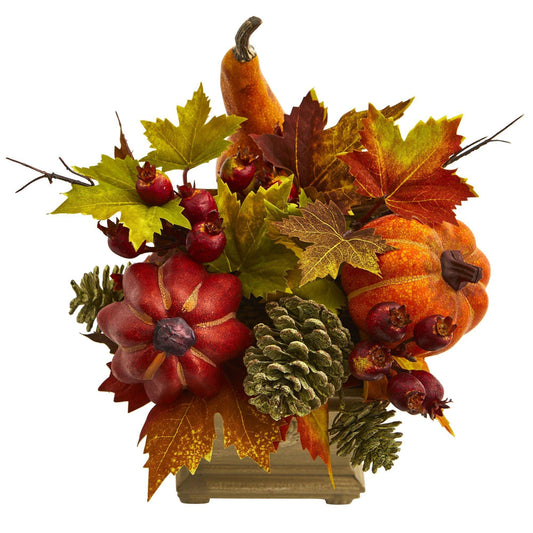 a decorative arrangement of pumpkins and leaves