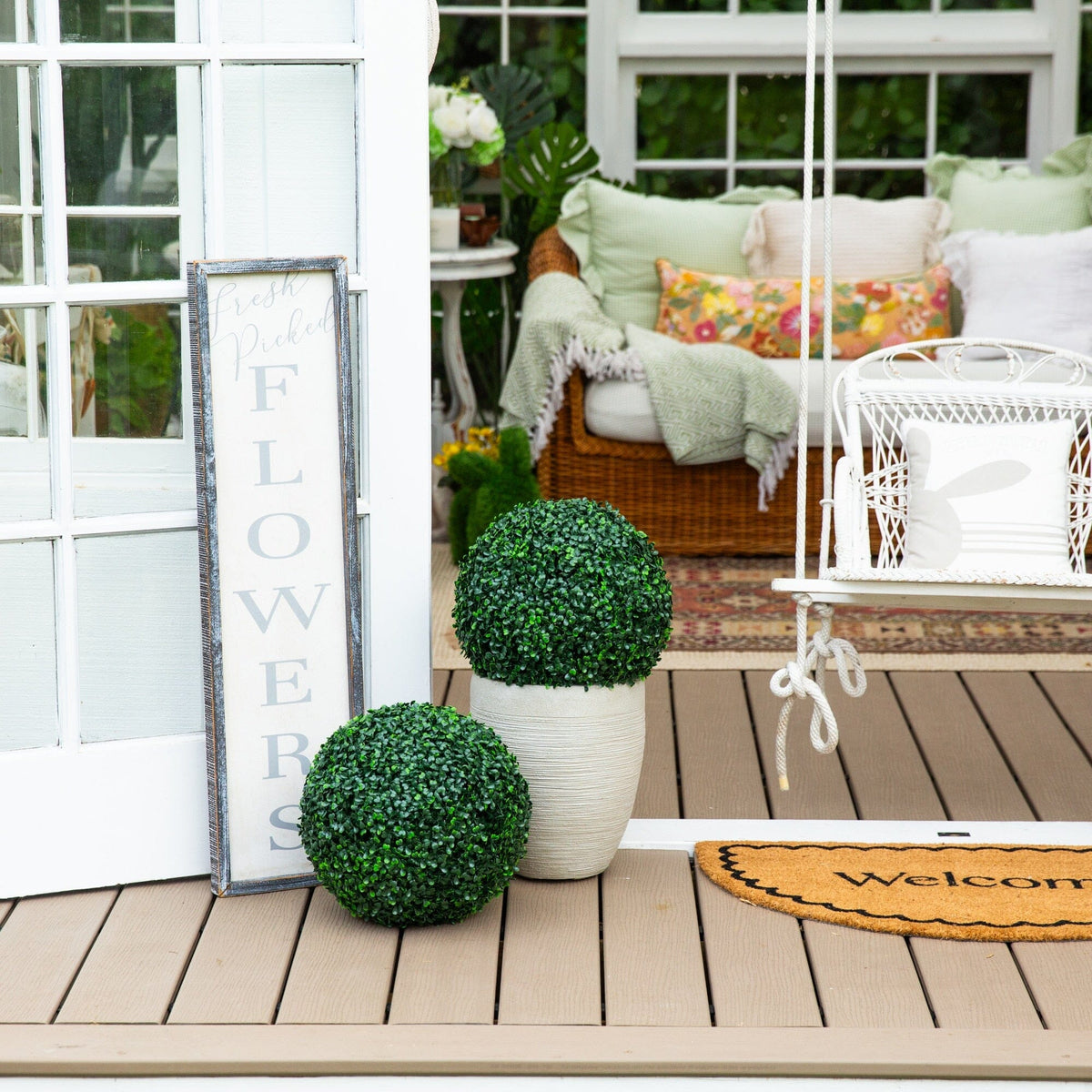 a porch with a swing and a door and a chair