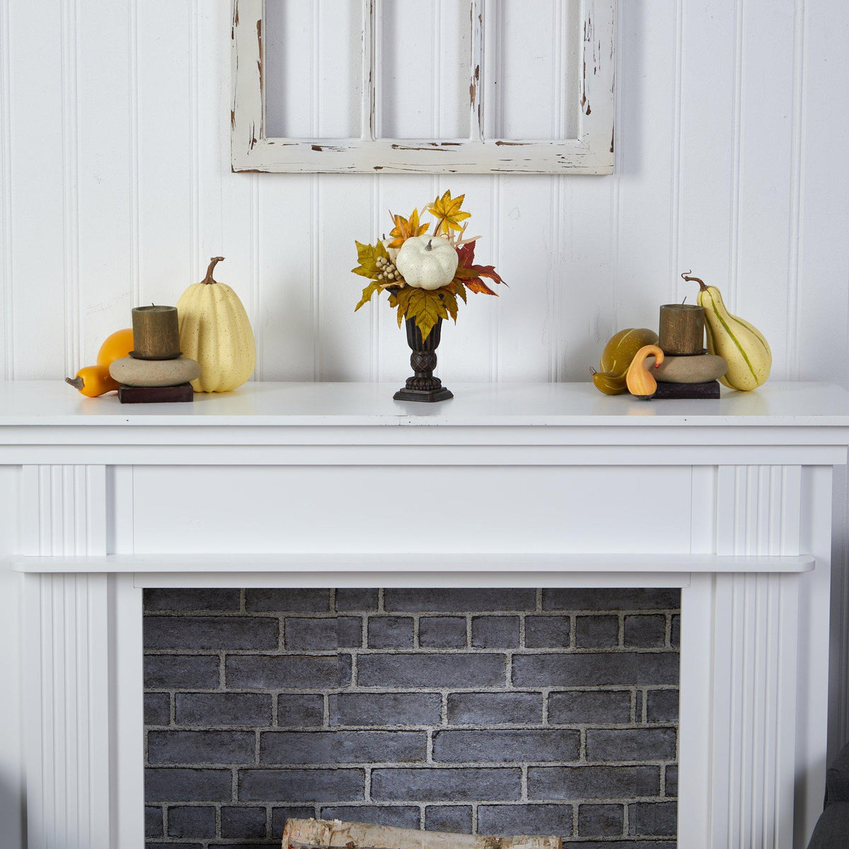 a white fireplace with pumpkins and gourds