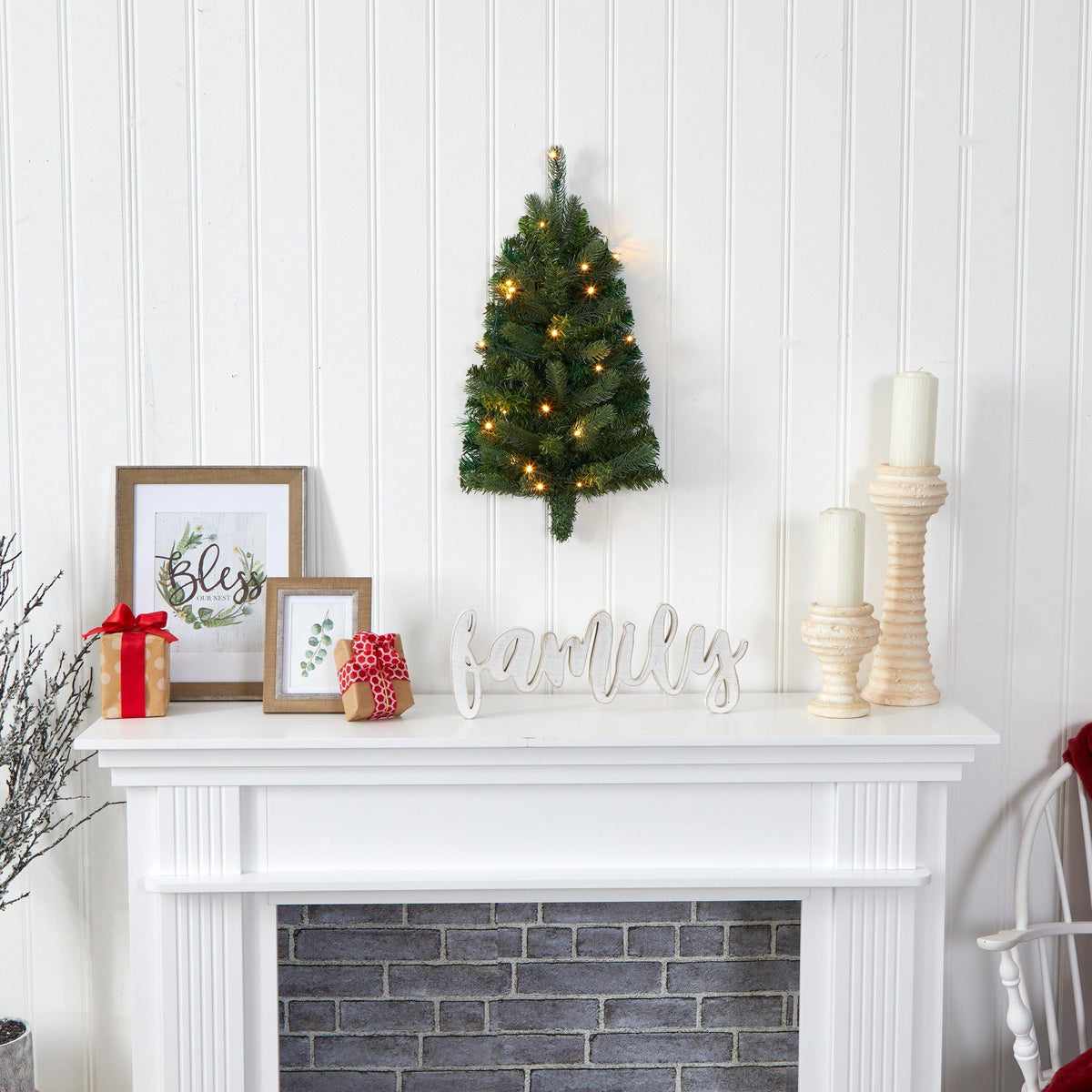 a fireplace with a small tree and candles