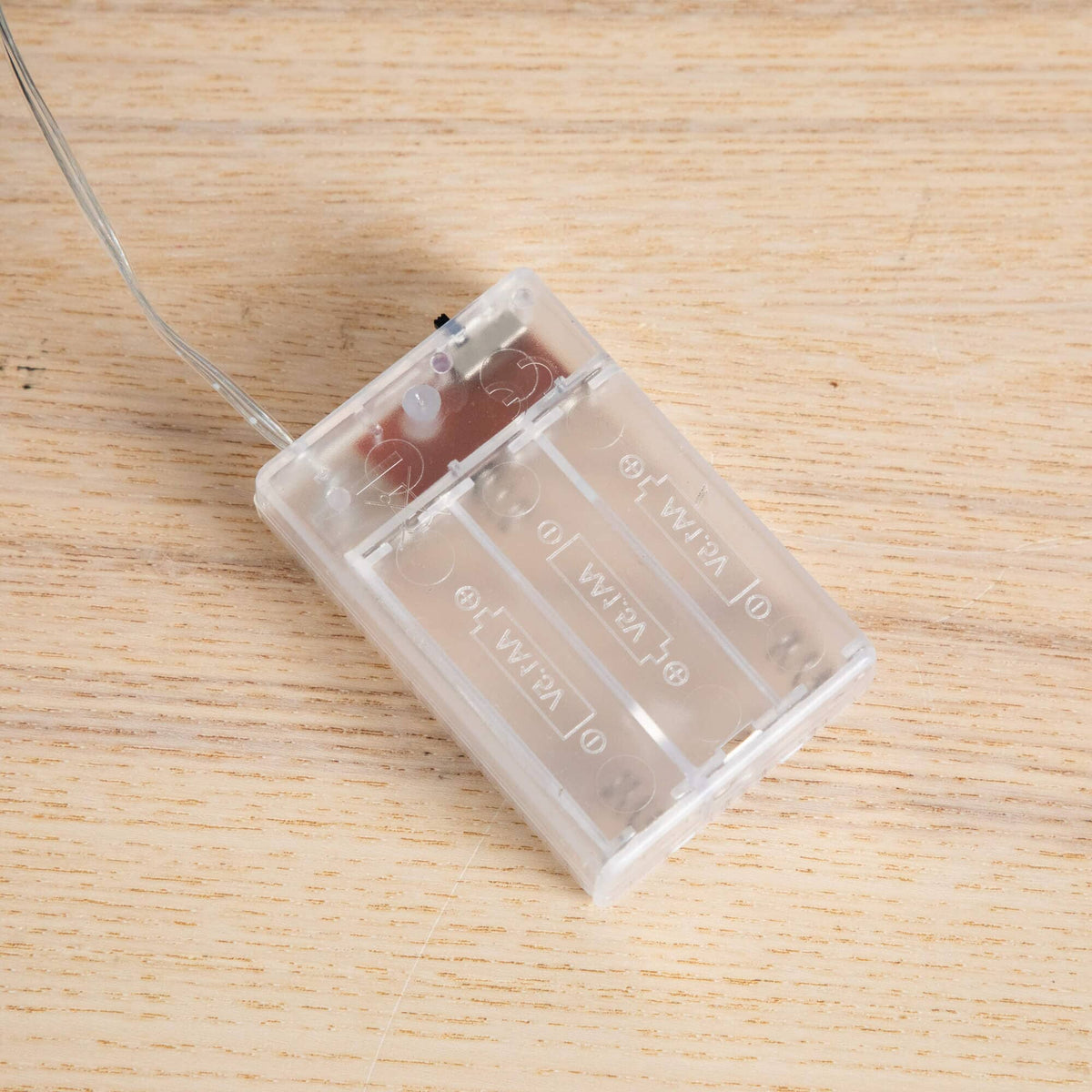 a clear plastic object with a wire