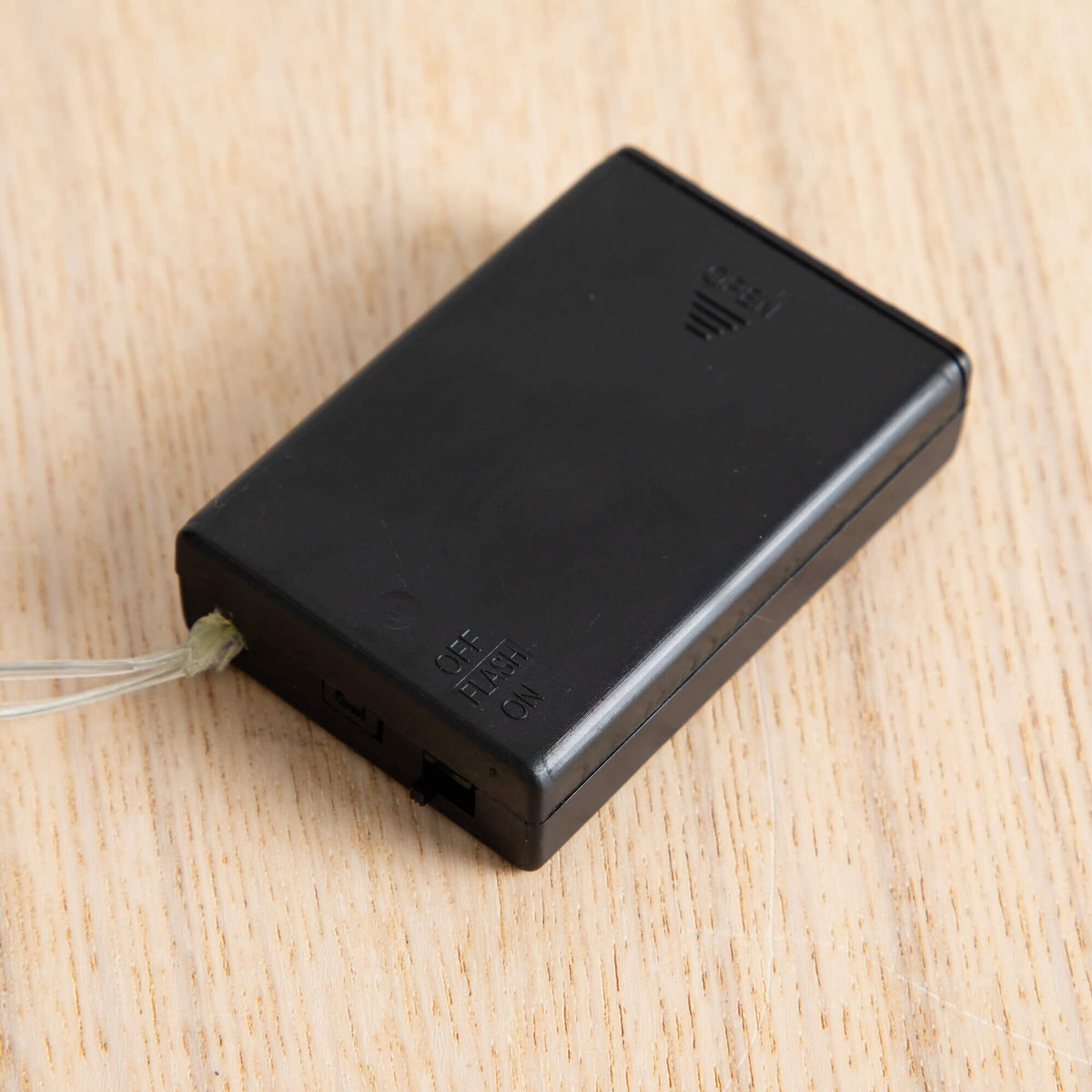 a black rectangular object with a white cord