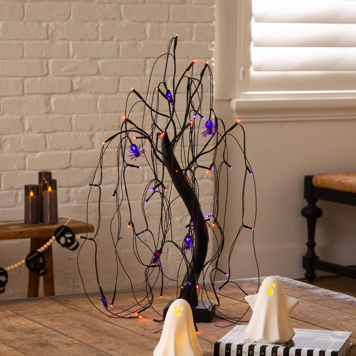 a tree with lights and ghosts on a table