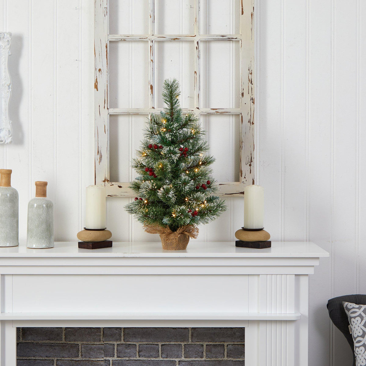 a small christmas tree on a white fireplace
