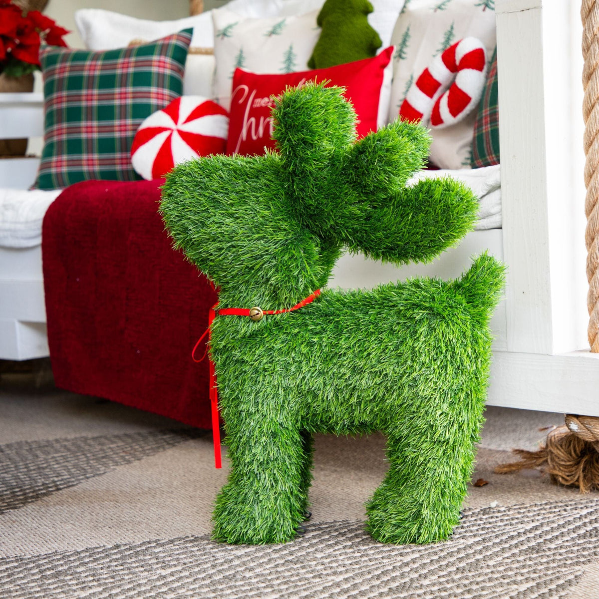 a green animal shaped object next to a bed