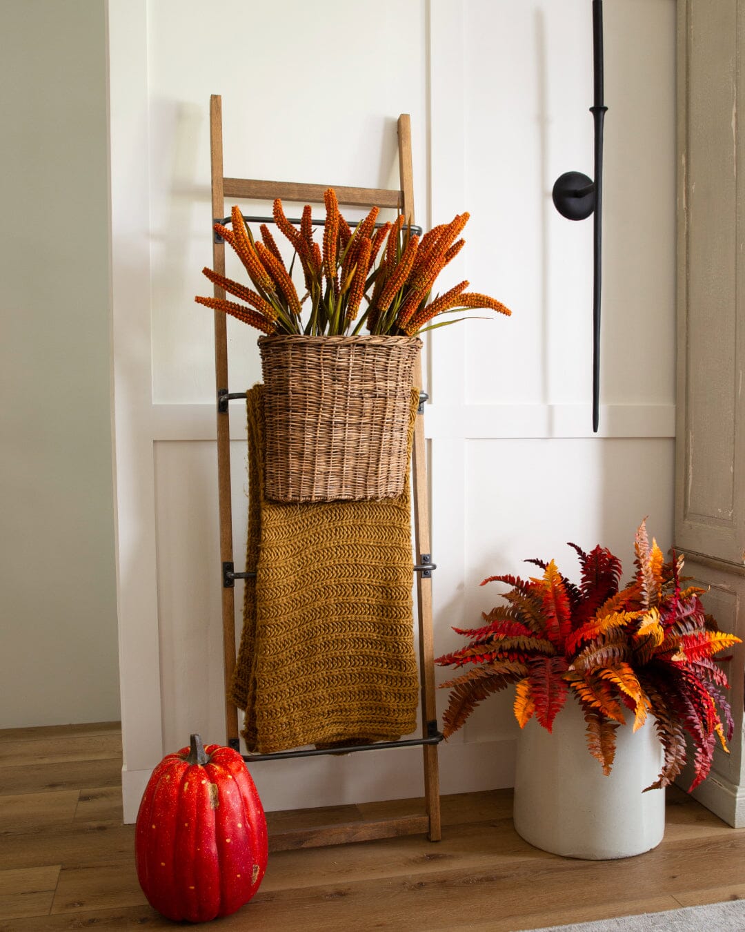 a basket of flowers and a pumpkin
