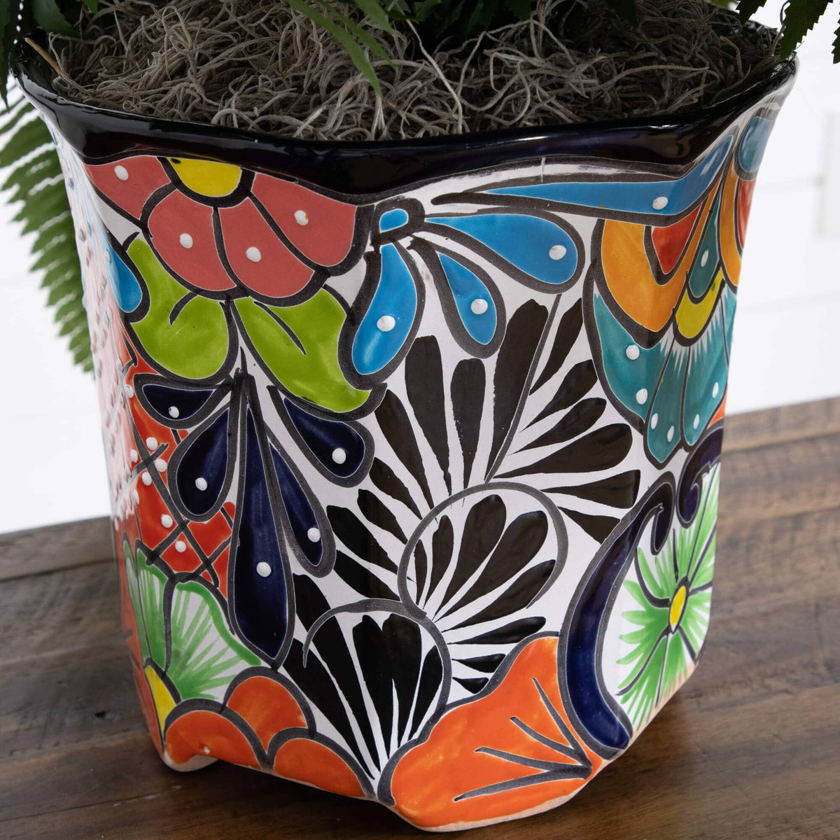 a colorful plant pot with a plant