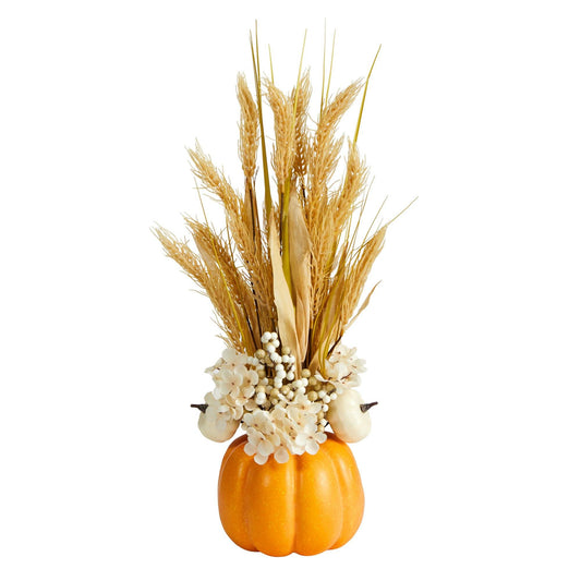 a pumpkin with wheat and flowers