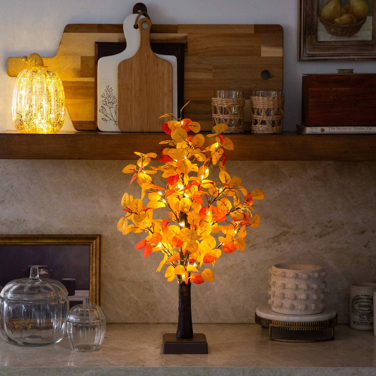 a small tree with yellow leaves on a counter