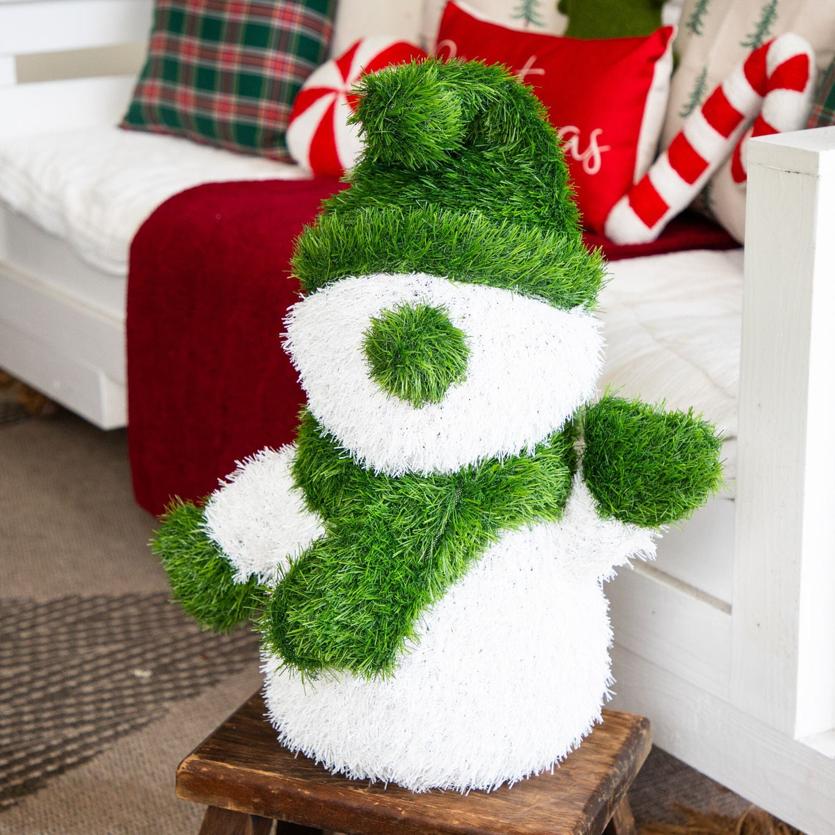 a green and white snowman statue