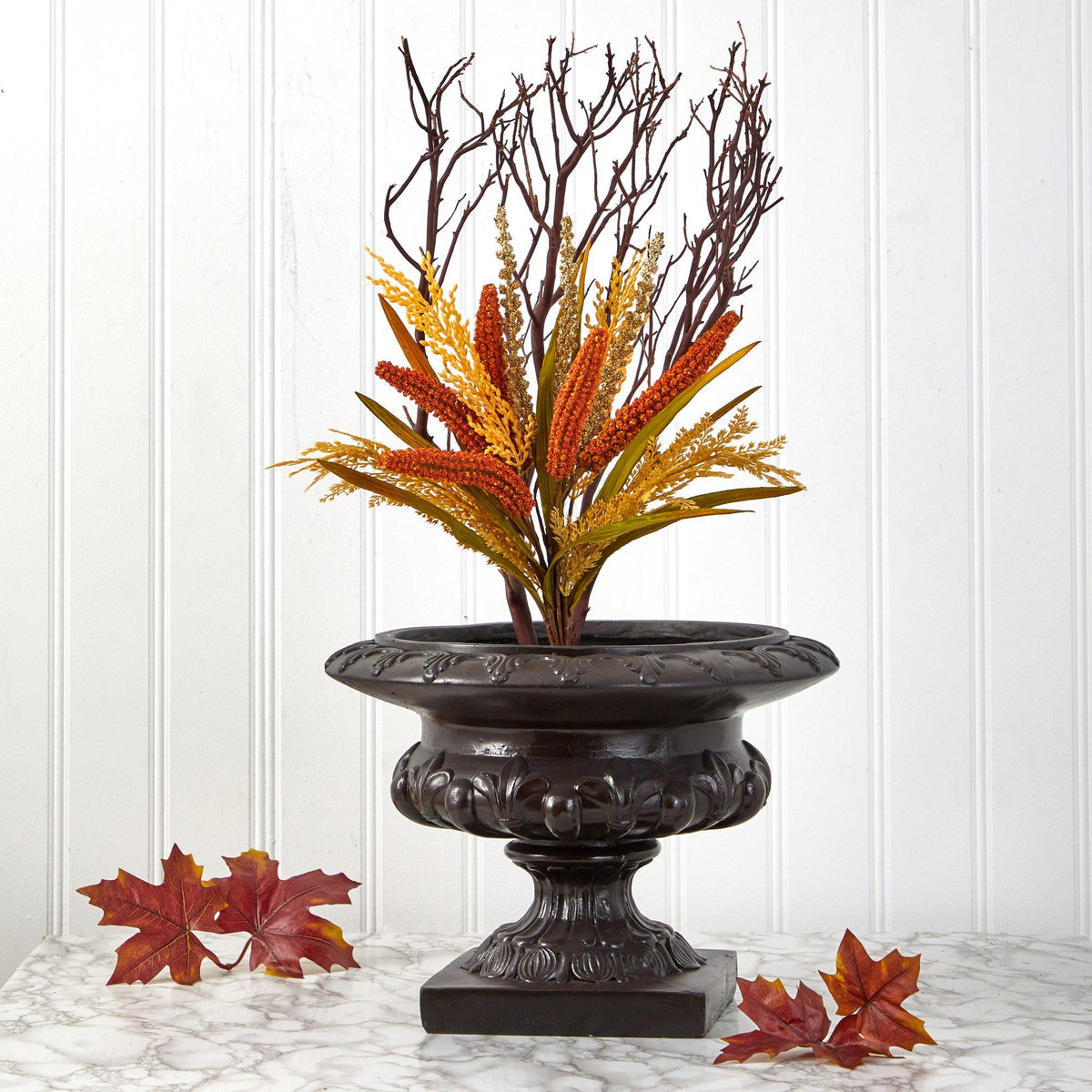 a vase with dried plants in it