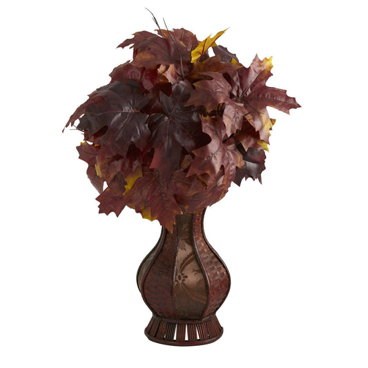 a vase with leaves in it