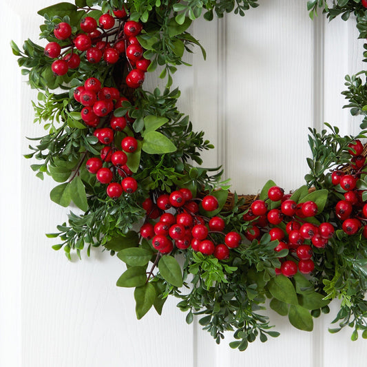 a wreath with red berries on it