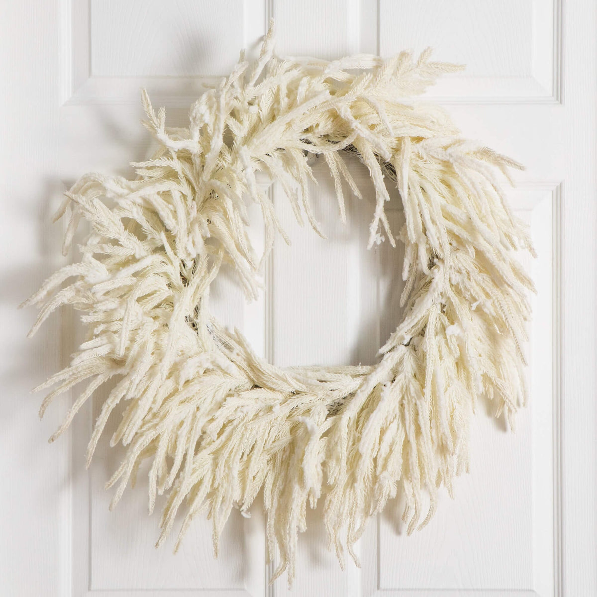a white wreath on a door