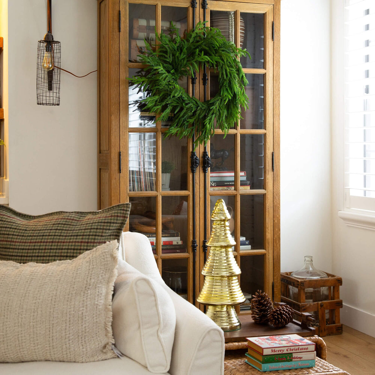 a wreath on a glass cabinet