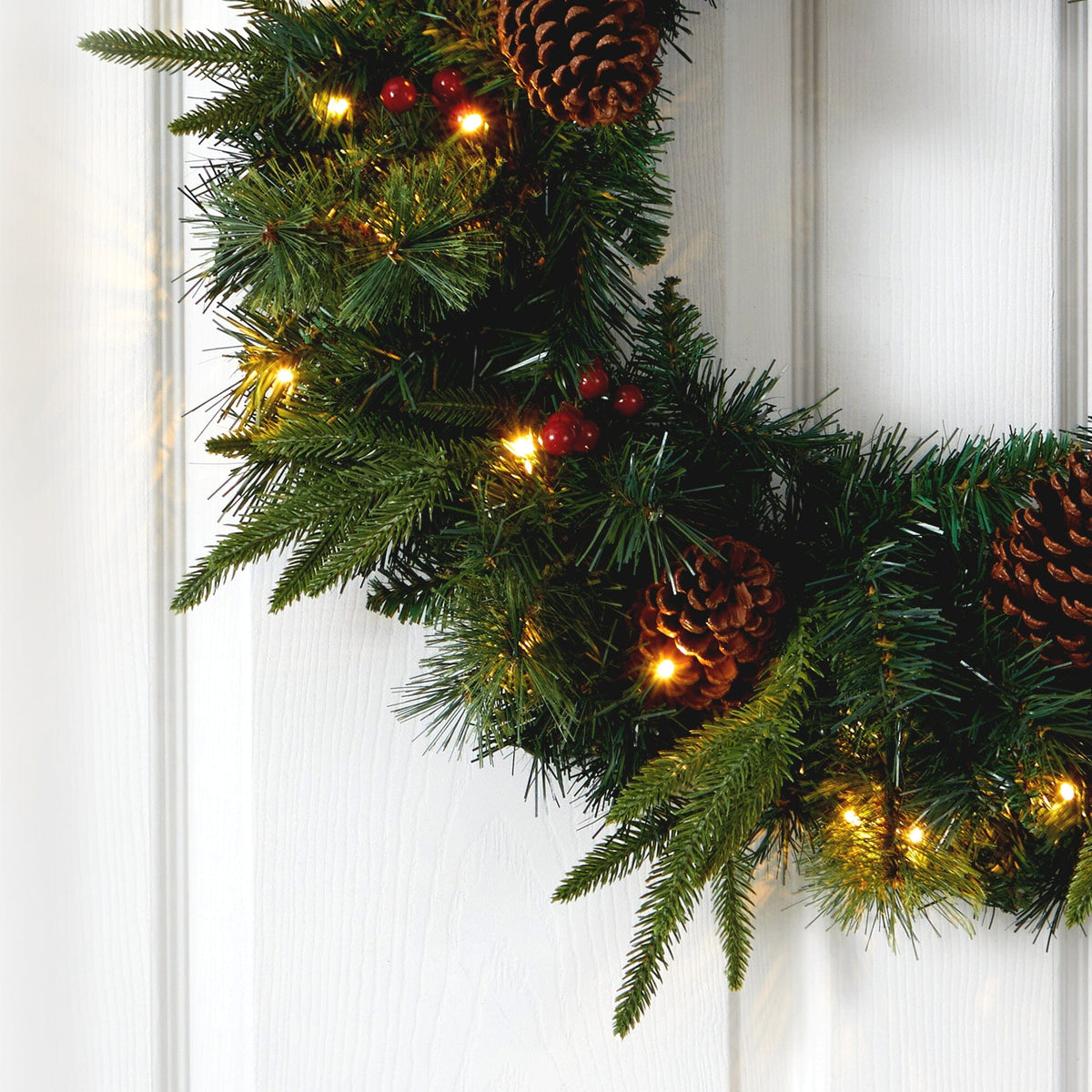 a wreath with pine cones and lights