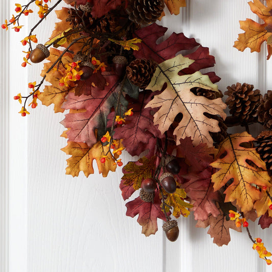 a wreath of leaves and pine cones