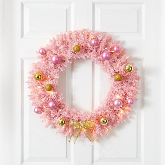 a pink wreath on a white door