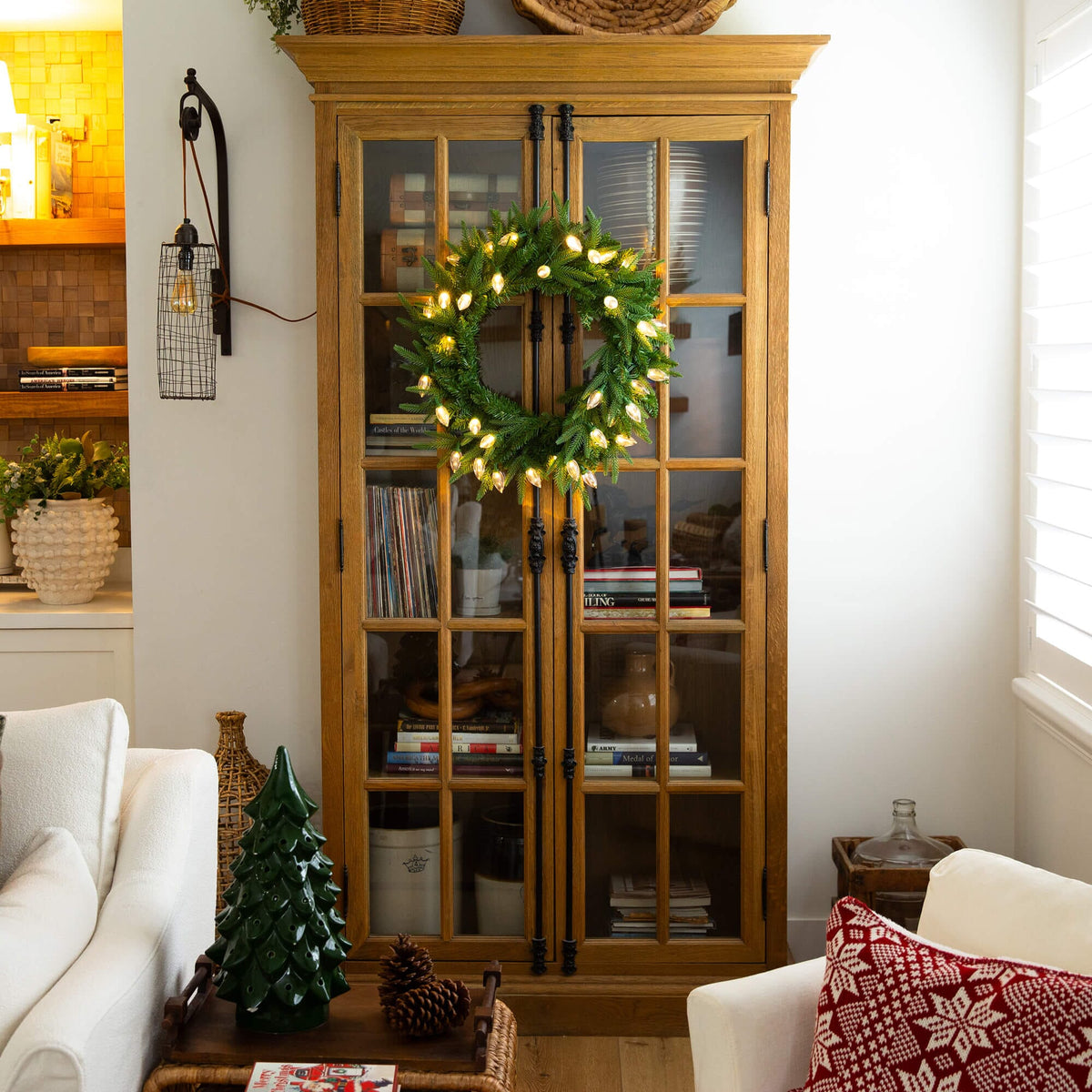 a wreath on a glass cabinet