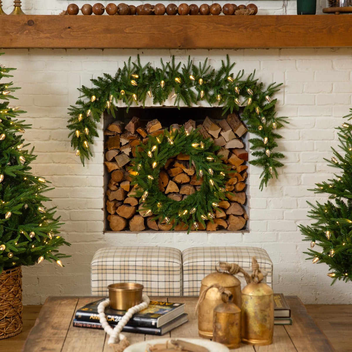 a fireplace with christmas wreaths and lights