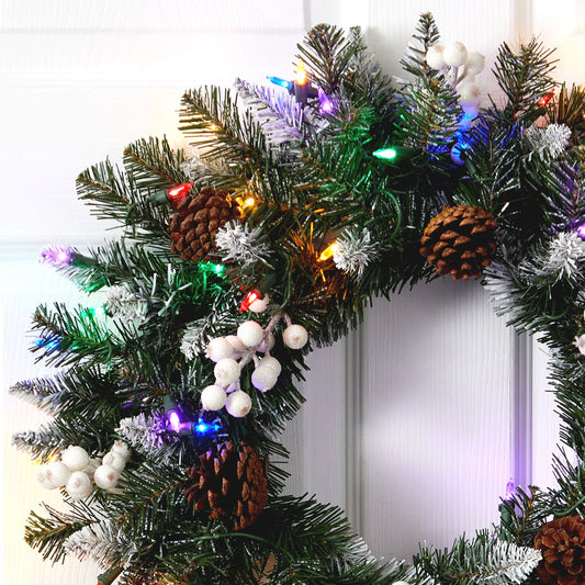 a wreath with lights and pine cones