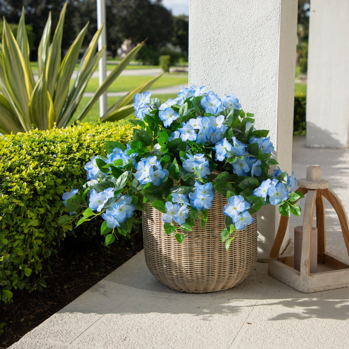 a basket of flowers next to a pillar
