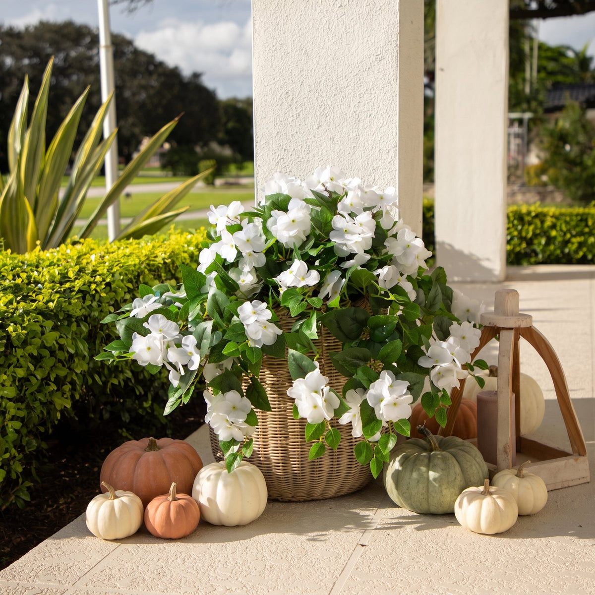 a basket of flowers and pumpkins