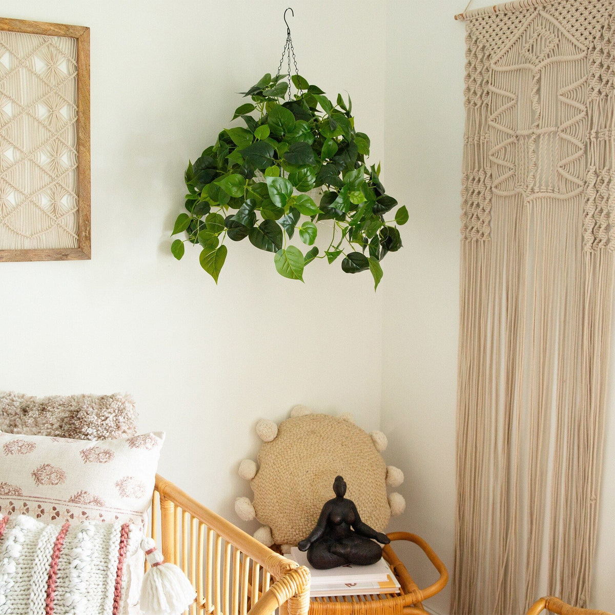 a room with a crib and a plant