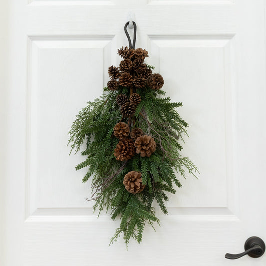 a pinecones and evergreen leaves on a door handle
