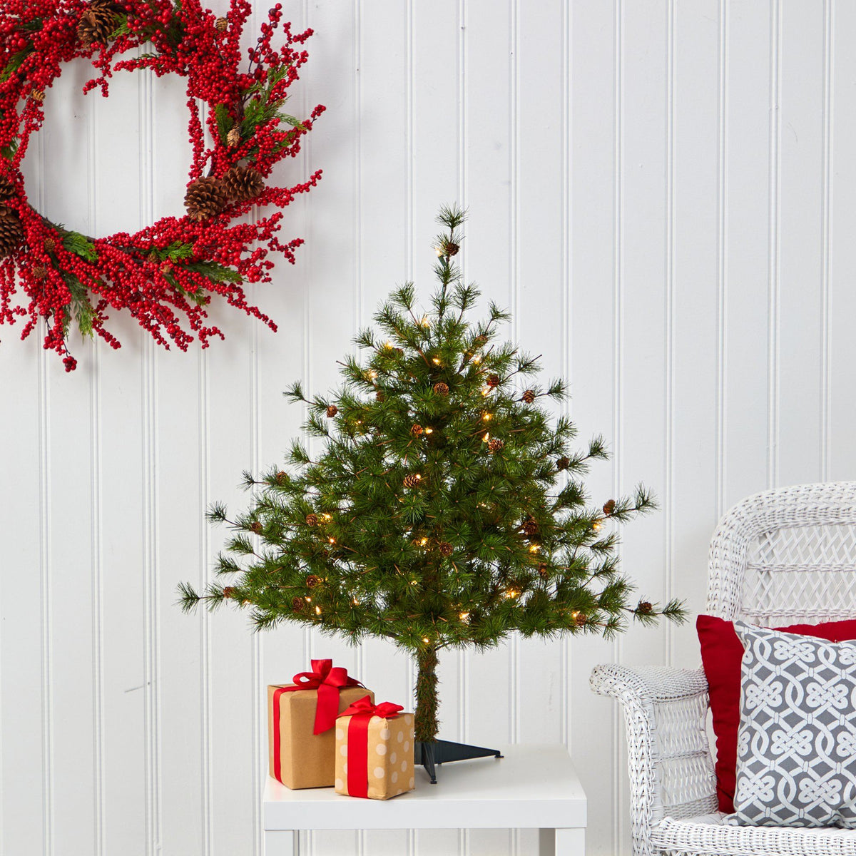 a christmas tree with lights and presents on a table
