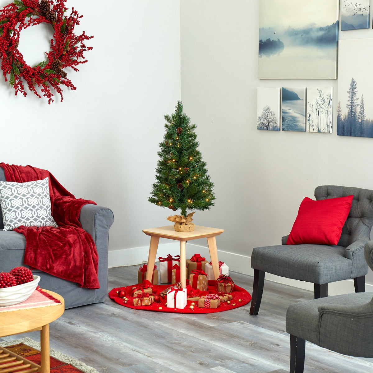 a living room with a small christmas tree