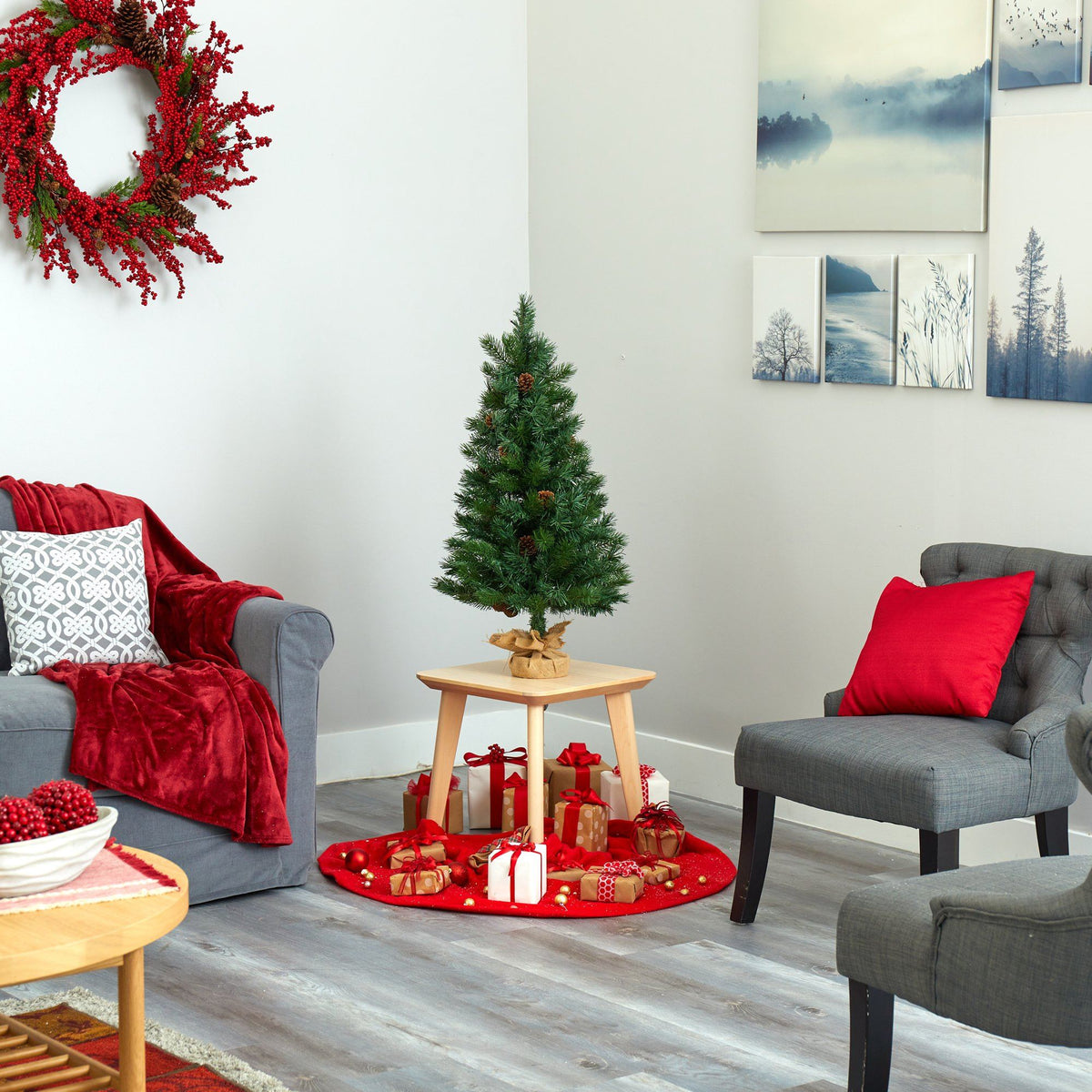 a living room with a christmas tree and chairs
