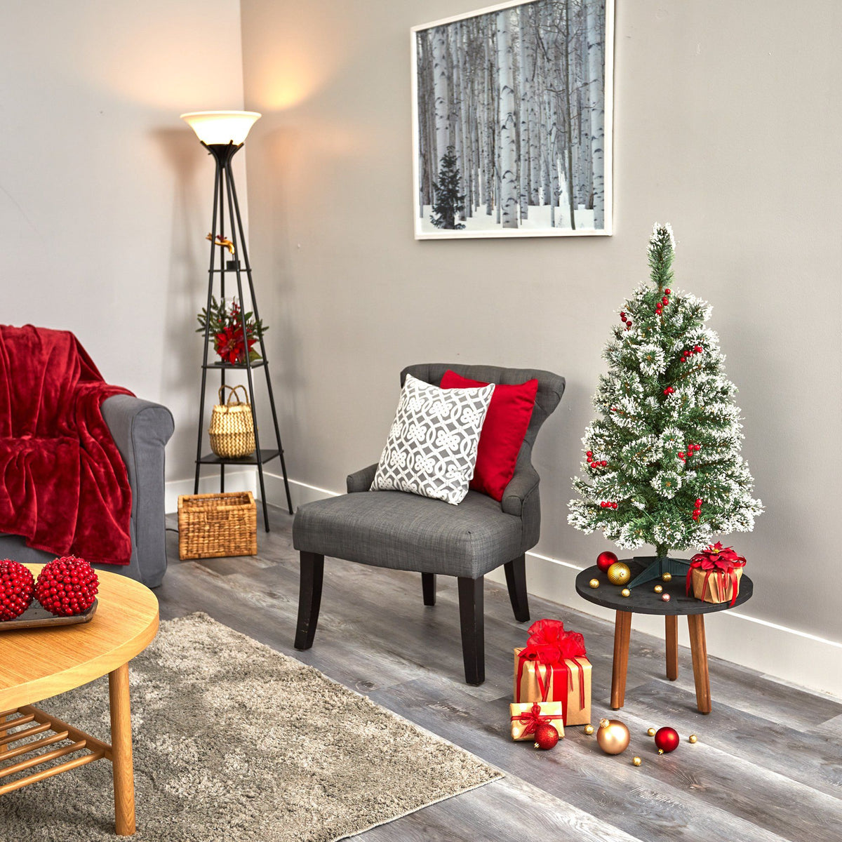 a living room with a small christmas tree and a chair
