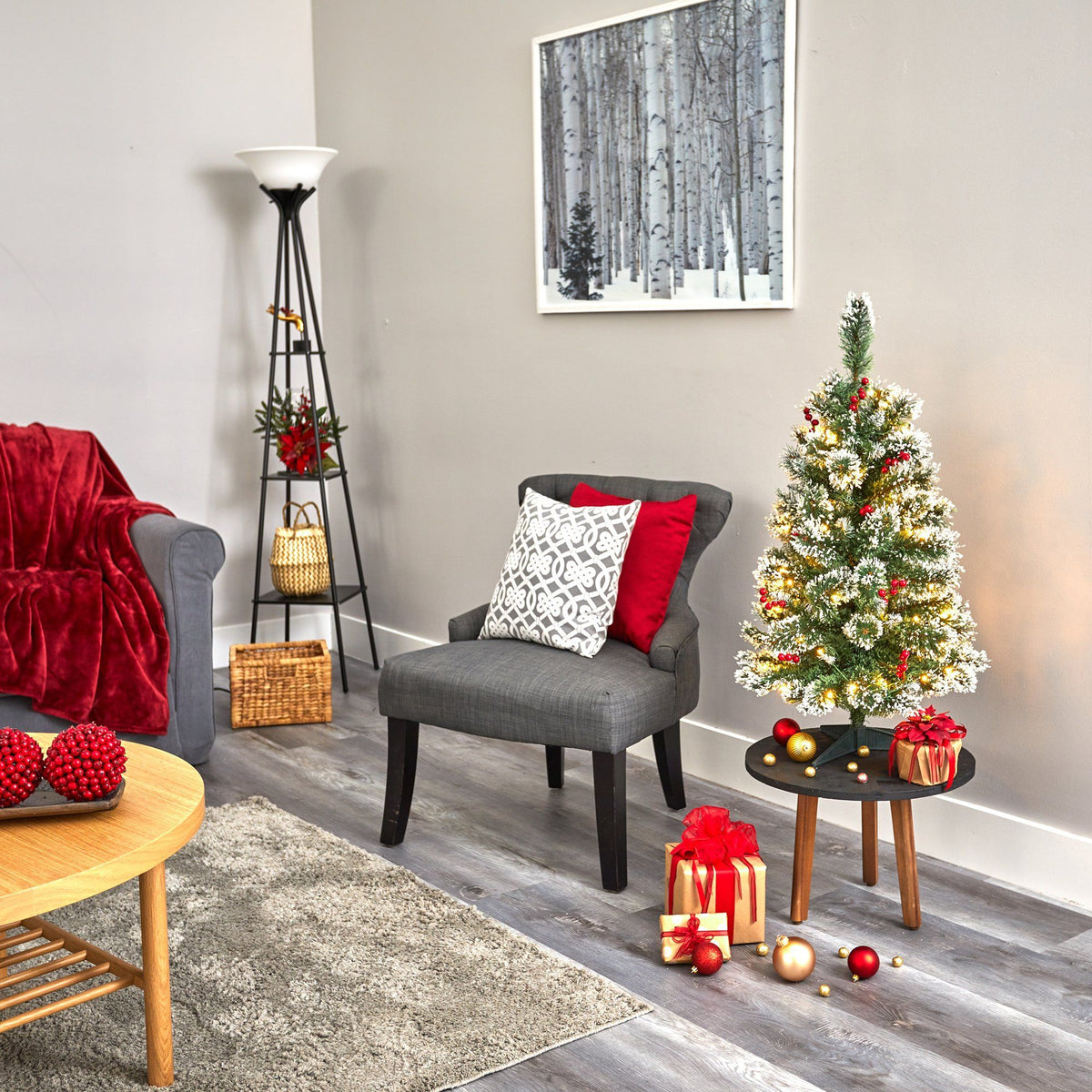 a living room with a small christmas tree and a couch