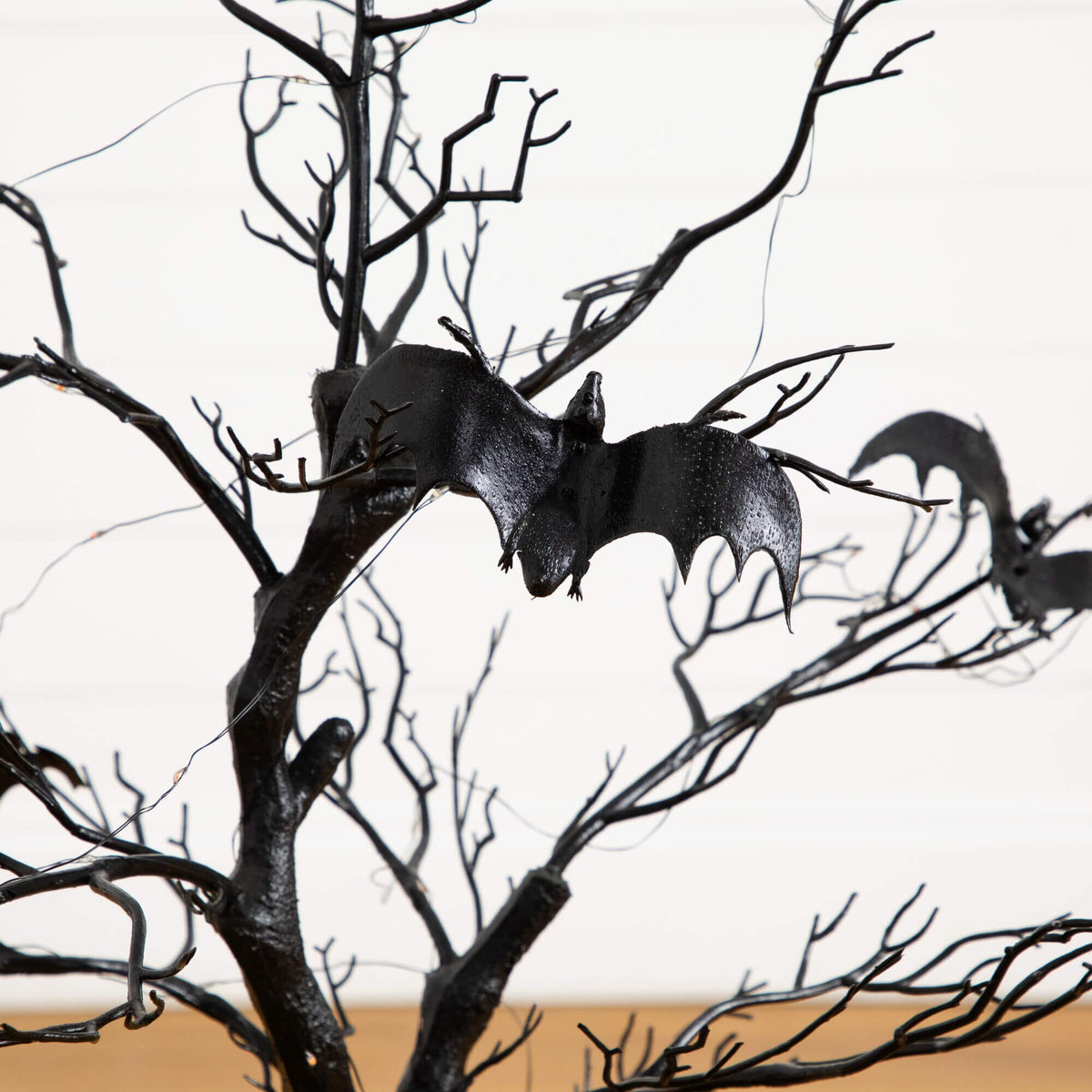 a black tree with bats on it