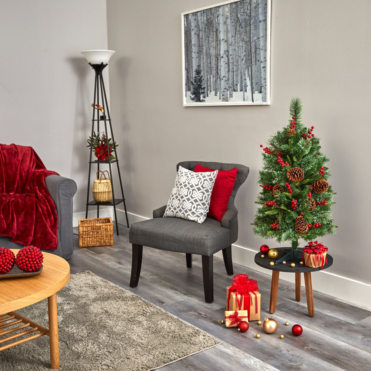 a living room with a small christmas tree and a small table