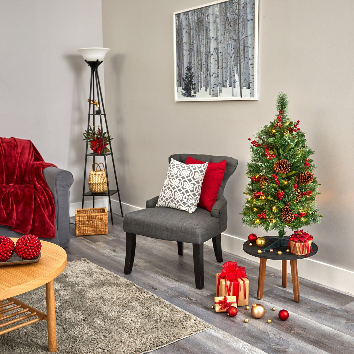 a living room with a small christmas tree and a small table