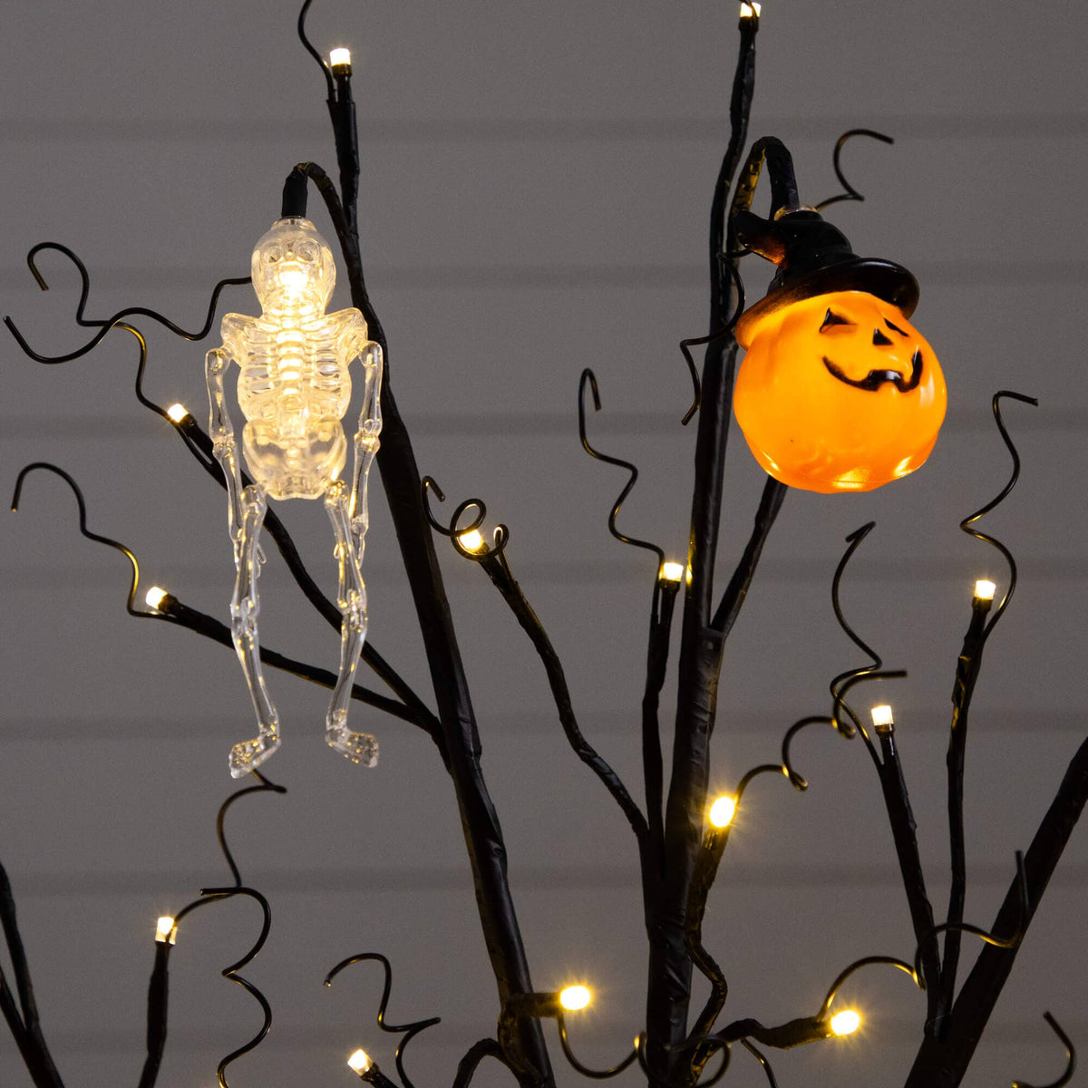 a tree with lights and a skeleton