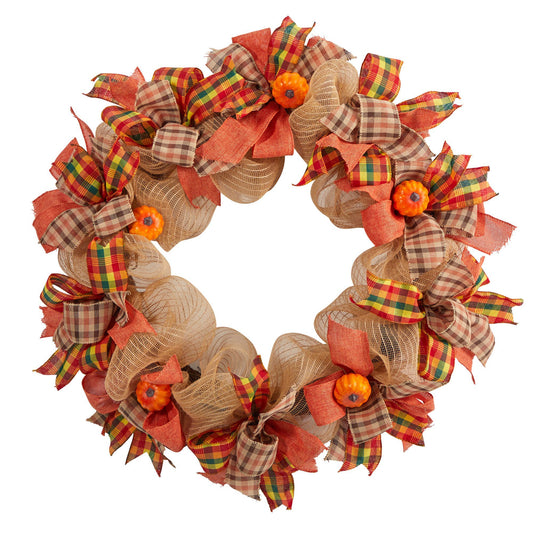 a wreath with pumpkins and plaid ribbons