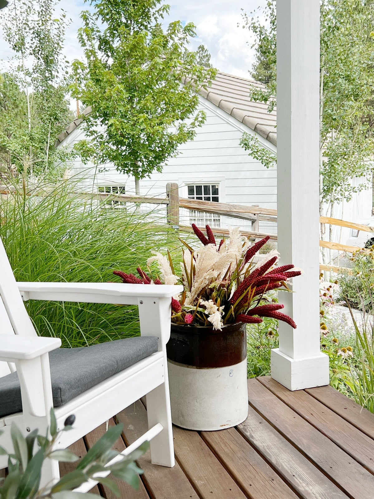 a white chair and potted plant on a porch